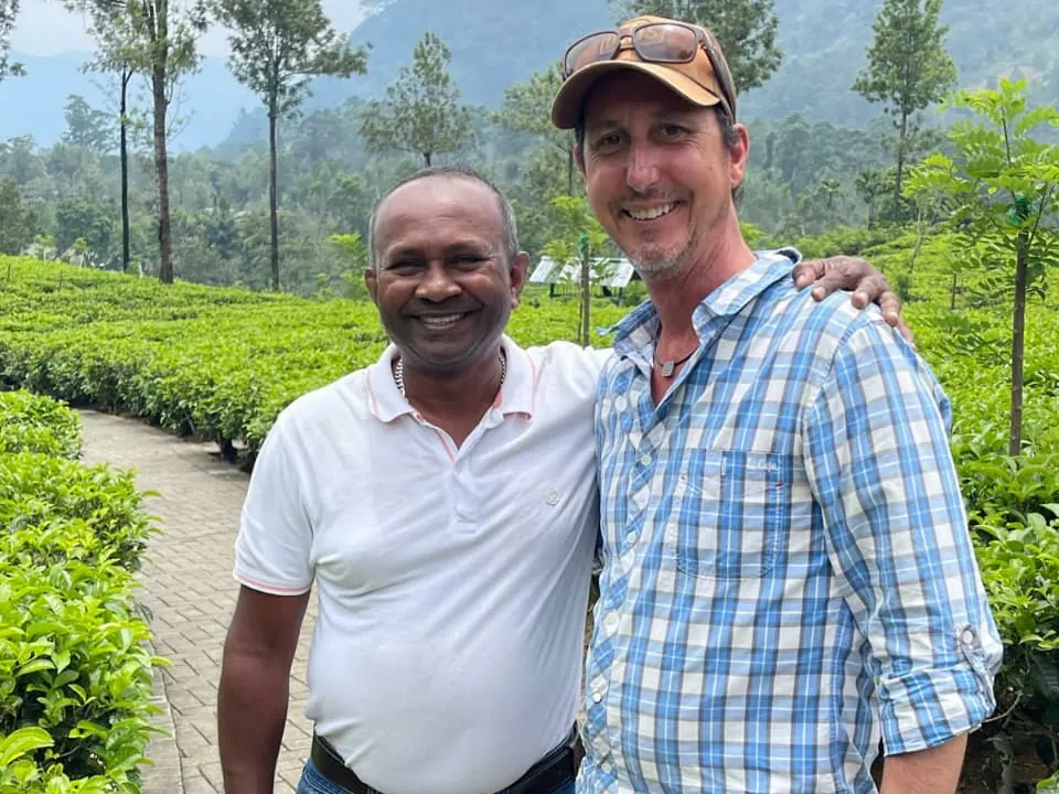 Tour guide Romesh with a tour guest at a tea plantation in the highlands of Sri Lanka.