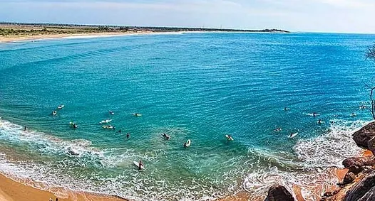 Surfers riding the waves at Arugam Bay