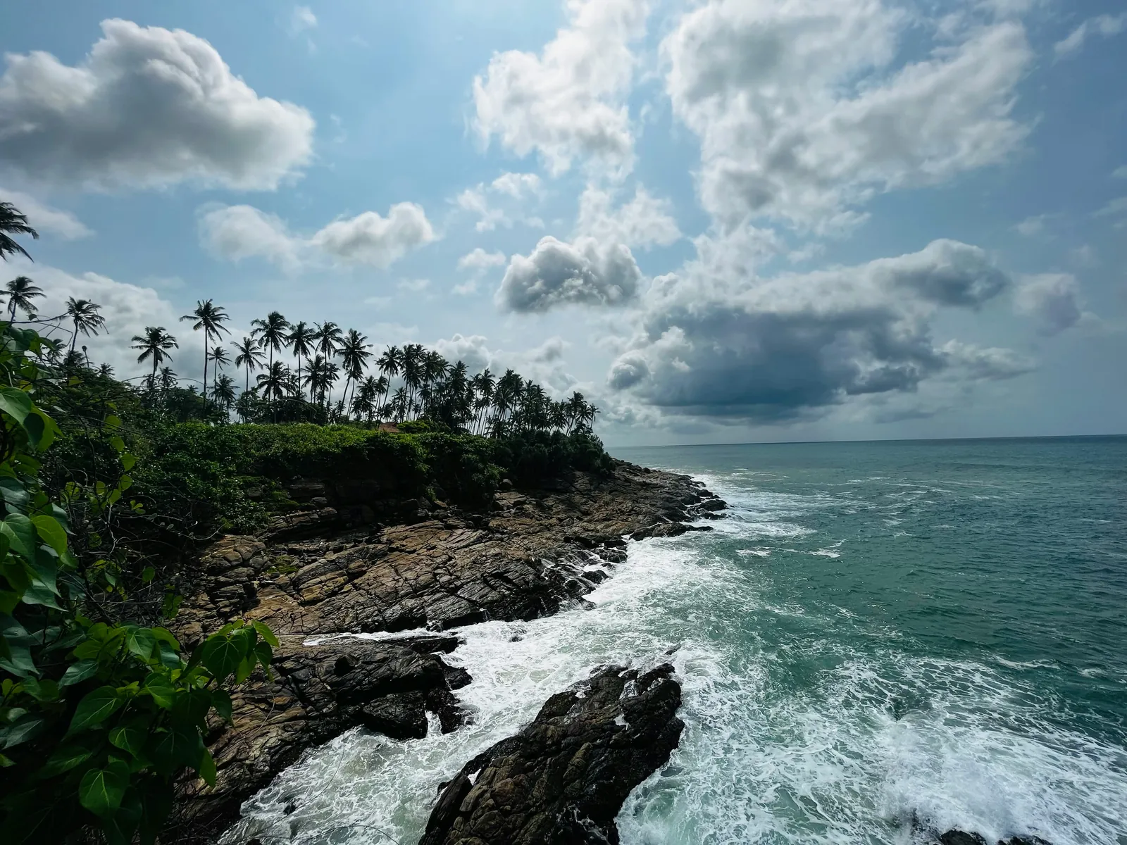 Palm-lined cliffs and turquoise water at Tangalle